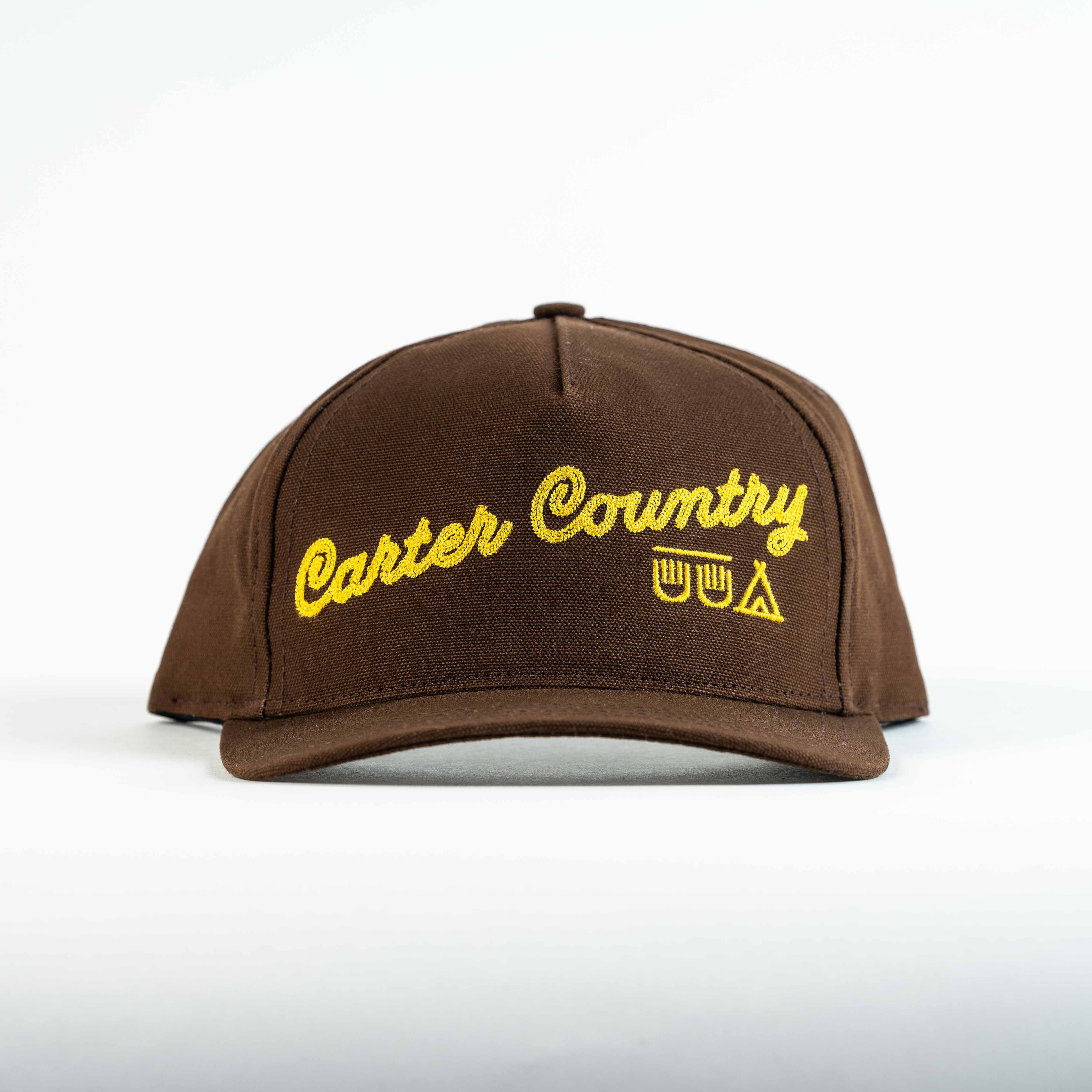 Front view of brown Trucker cap with yellow Carter Country Stitch and yellow ten sleep in native american symbols