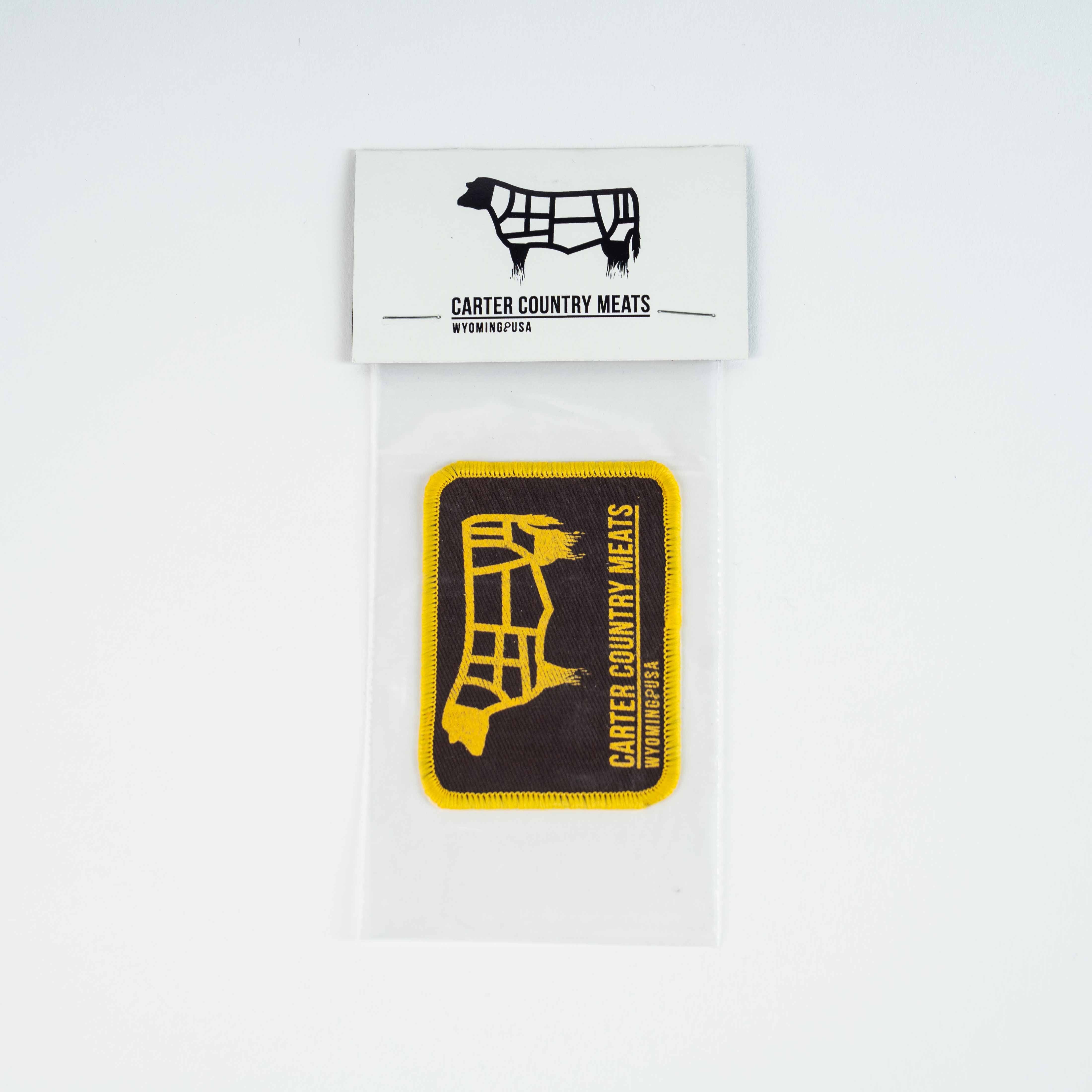Yellow cow outline/yellow Carter Country Meats Wyoming USA Text on brown iron on patch