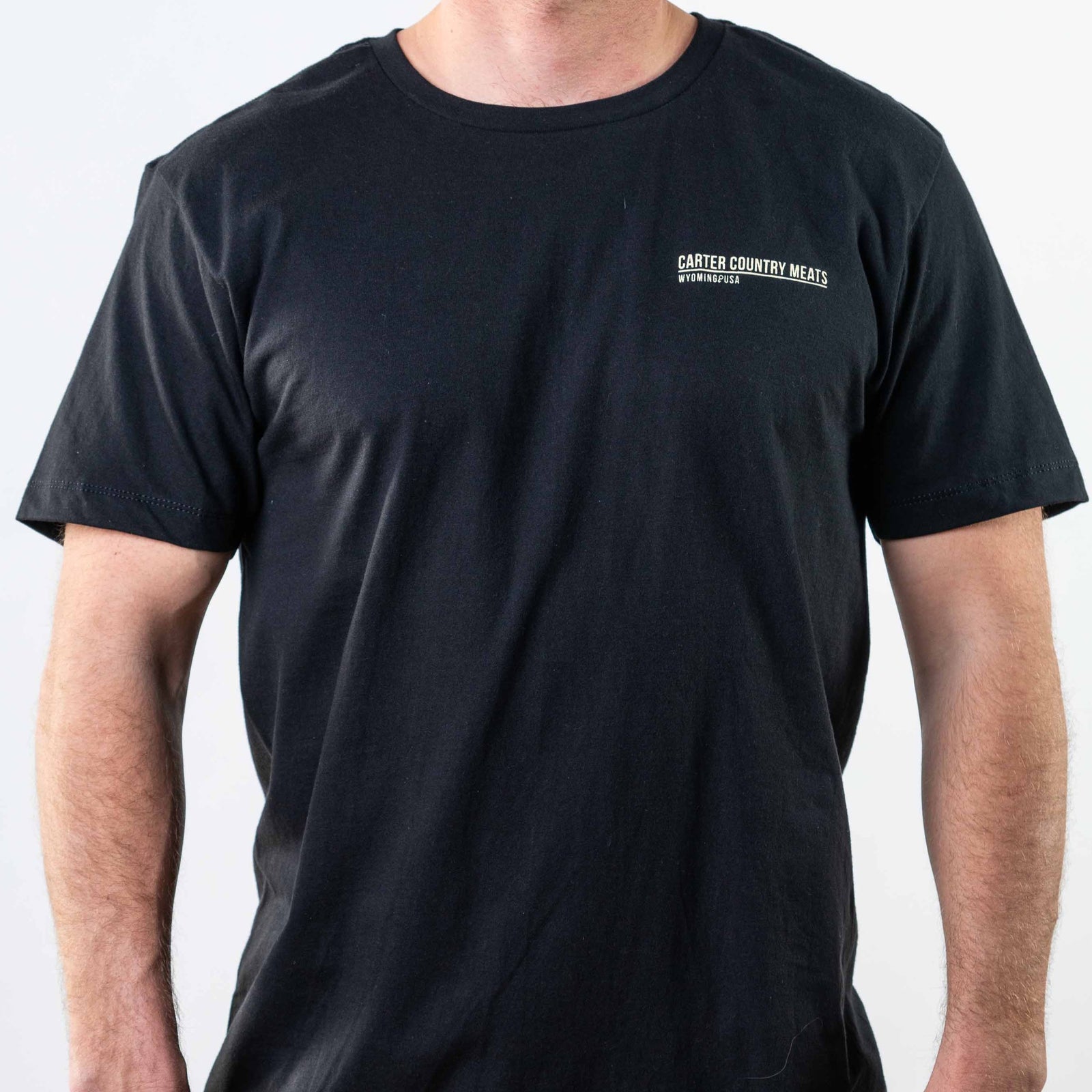 Black tee modeled front view with carter country meats printed upper left chest