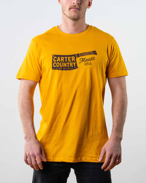 modeled front view mustard colored tee with butcher knife and carter country meats text. ten sleep in native american symbols